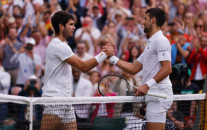 Carlos Alcaraz shaking hands with Novak Djokovic