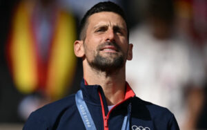 Novak Djokovic on the podium with the medal