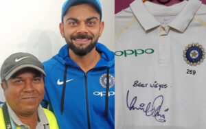 Debasis Sen with Virat Kohli and Kohli's signed jersey for him from the BGT 2018