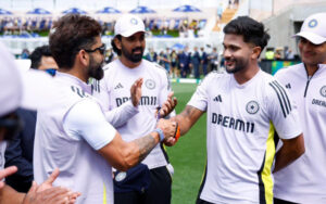 Nitish Kumar Reddy receiving his debut cap from Virat Kohli