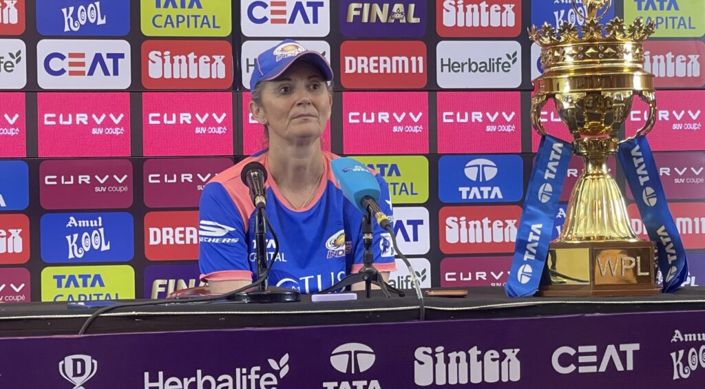 MI coach Charlotte Edwards with the WPL trophy at the post-match presser