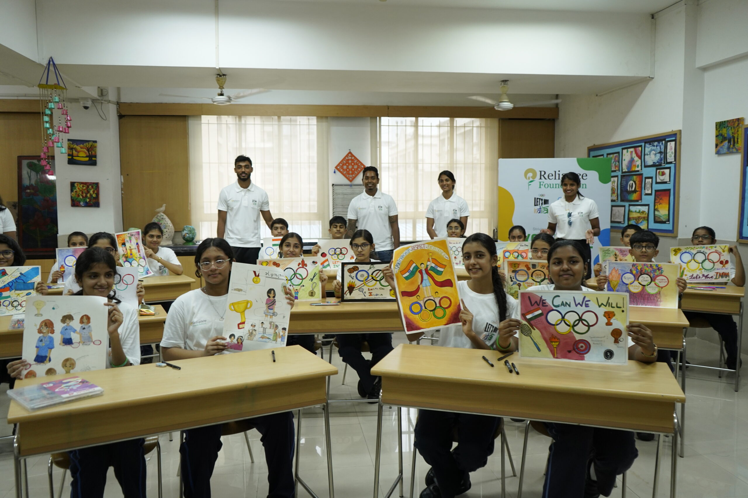 Reliance Foundation School children flaunt their art work for Let's Move India event in the presence of supported athletes